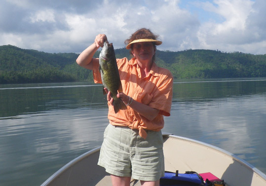 Paula Begley holding a nice smallmouth bass caught on June 11, 2013 while fly fishing on an area lake..